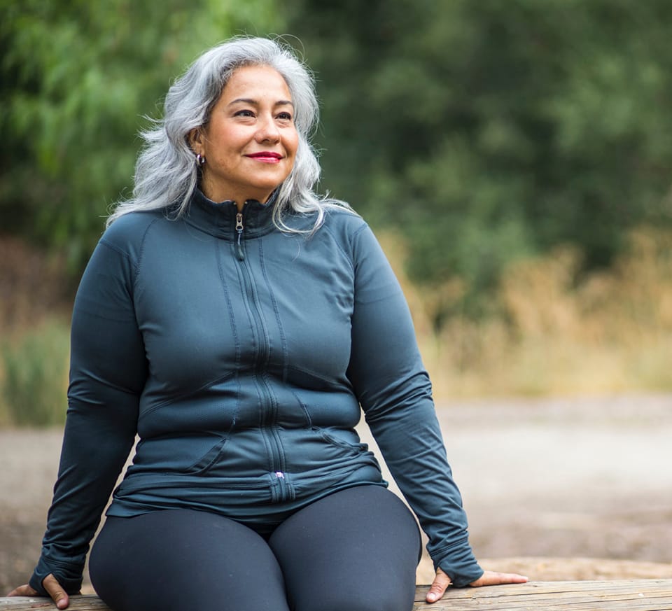 older woman in a track suit sitting